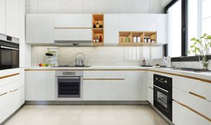 L-shaped modular kitchen design in a Kottayam home by Interio Interiors